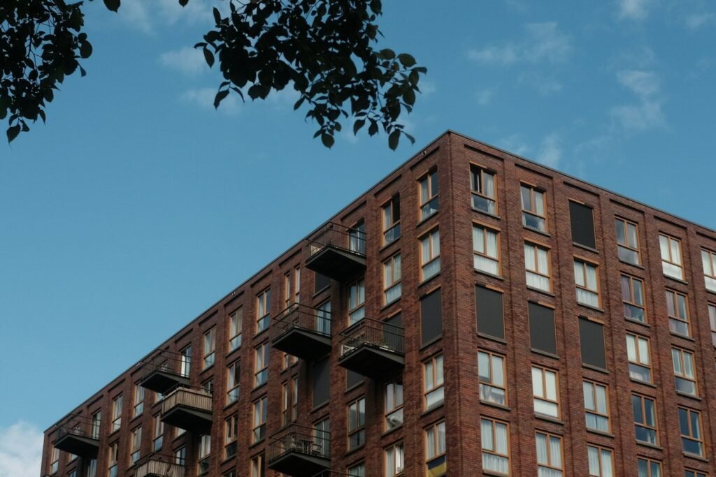 Modern brick building with balconies against blue sky